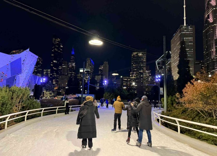 Ice skating in Chicago on the ribbon with the buildings lit up all around.