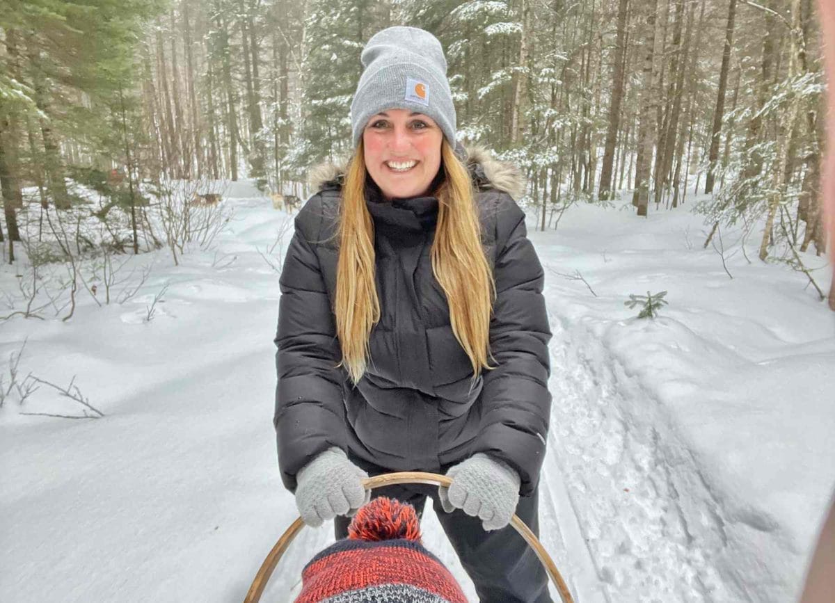 Bryanna driving the dog sled.