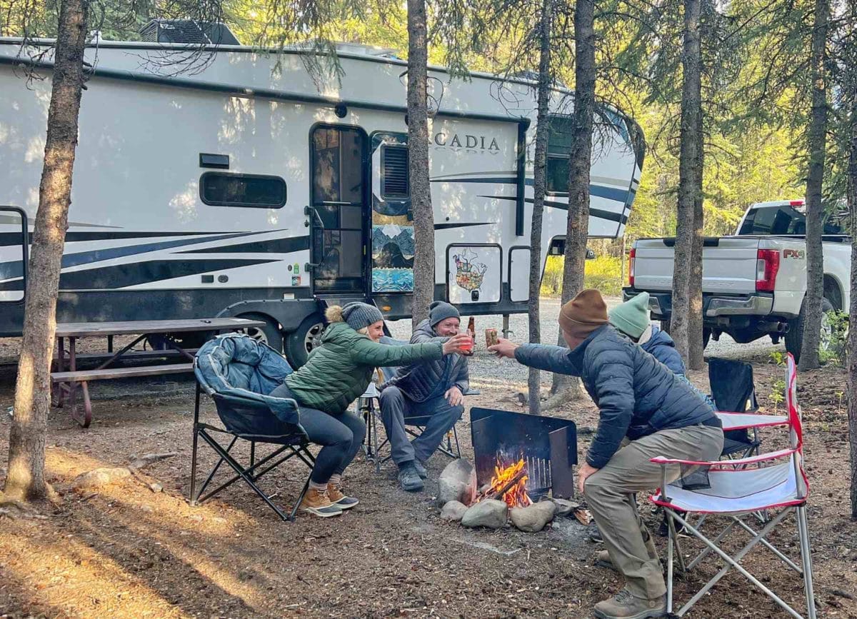 2 couples hitting their drinks together in a cheers in front of their Keystone Arcadia.